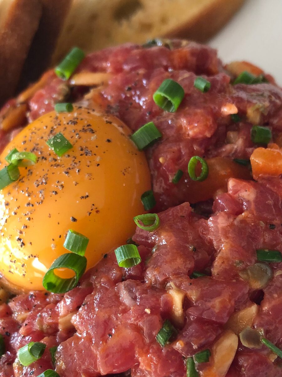 Beef tartare with egg yolk and spring onion